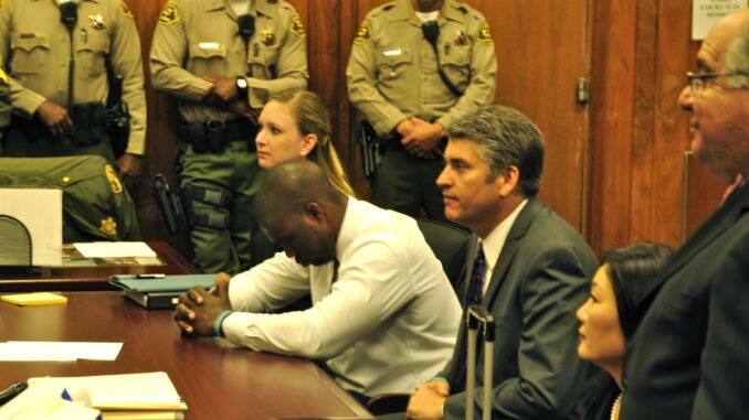 The moment Brian Banks is finally exonerated. From left: Alissa Bjerkhoel, Brian Banks, Justin Brooks. Photo credit: Heidi Brooks.